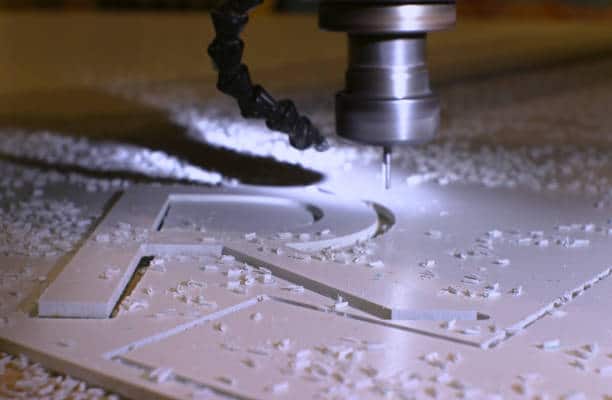 Cutting the letters of the alphabet from plastic on a milling machine. Close-up, background.